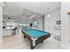 Expansive game room with a pool table, bar seating, and access to the living room and kitchen at 630 Coronado Dr, Punta Gorda, FL 33950