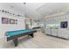 Open-concept game room with pool table, recessed lighting, and bar seating with easy access to the kitchen at 630 Coronado Dr, Punta Gorda, FL 33950