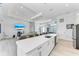 Open-concept kitchen seamlessly connects to the living and game room, offering a perfect entertainment space at 630 Coronado Dr, Punta Gorda, FL 33950