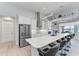 Modern kitchen featuring a large island with seating, stainless steel appliances, and ample cabinet space at 630 Coronado Dr, Punta Gorda, FL 33950