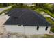 New construction home with a dark-colored roof and white exterior walls at 2502 Pinewood St, North Port, FL 34288