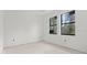 Bright bedroom featuring two windows and unfinished flooring at 2502 Pinewood St, North Port, FL 34288