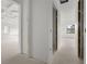 Unfinished hallway with drywall and doorways to other rooms at 2502 Pinewood St, North Port, FL 34288