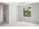 Unfurnished bedroom with large window overlooking wooded area at 2502 Pinewood St, North Port, FL 34288