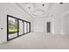 Bright living room featuring large windows and sliding glass doors at 2502 Pinewood St, North Port, FL 34288