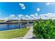 Peaceful canal front view with lush landscaping at 630 Coronado Dr, Punta Gorda, FL 33950
