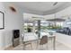 Bright dining area with glass table and chairs, overlooking the pool and patio at 630 Coronado Dr, Punta Gorda, FL 33950