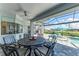 Covered patio with seating area, overlooking the pool and canal at 630 Coronado Dr, Punta Gorda, FL 33950