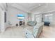 Spacious living room with light-colored sofas and a pool table at 630 Coronado Dr, Punta Gorda, FL 33950