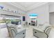 Spacious living room with light grey sofas and pool view at 630 Coronado Dr, Punta Gorda, FL 33950