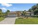 Single-story home with a screened garage and landscaped yard at 2208 Barksdale St, Port Charlotte, FL 33948
