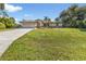 Single-story house with a large front yard and driveway at 2208 Barksdale St, Port Charlotte, FL 33948