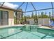Enjoy the refreshing pool and spa, surrounded by lush greenery at 2208 Barksdale St, Port Charlotte, FL 33948