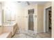 Main bathroom with double sinks, shower, and linen closet at 2208 Barksdale St, Port Charlotte, FL 33948