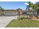 Single story home with a two-car garage and landscaping at 2208 Barksdale St, Port Charlotte, FL 33948