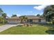 Single story home with a two car garage and front yard at 2208 Barksdale St, Port Charlotte, FL 33948
