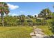 Landscaped backyard with canal access, offering serene views at 2208 Barksdale St, Port Charlotte, FL 33948