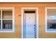 Condo building exterior with white door and tan walls at 3228 Purple Martin Dr # 113, Punta Gorda, FL 33950