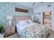 Bedroom with wood platform bed and leafy green wall decor at 3228 Purple Martin Dr # 113, Punta Gorda, FL 33950