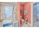 Bathroom with a tub, shower, and coral-colored walls at 3228 Purple Martin Dr # 113, Punta Gorda, FL 33950