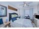 Cozy bedroom with a dark-blue headboard and a ceiling fan at 3228 Purple Martin Dr # 113, Punta Gorda, FL 33950