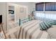 Bedroom with teal metal bed frame, striped bedding, and access to another bedroom at 3228 Purple Martin Dr # 113, Punta Gorda, FL 33950
