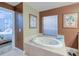 Relaxing bathroom with a large garden tub and access to the bedroom at 3228 Purple Martin Dr # 113, Punta Gorda, FL 33950