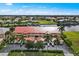 Aerial view of waterfront condo building with red tile roof and lush landscaping at 3228 Purple Martin Dr # 113, Punta Gorda, FL 33950