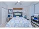 Bedroom with navy headboard, blue and white bedding, and built-in shelving at 3228 Purple Martin Dr # 113, Punta Gorda, FL 33950