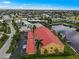 Aerial view of waterfront condo building with red tile roof and private parking at 3228 Purple Martin Dr # 113, Punta Gorda, FL 33950