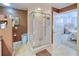 Bathroom with glass shower, and view into bedroom at 3228 Purple Martin Dr # 113, Punta Gorda, FL 33950