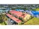 Aerial view of waterfront condo building with red tile roofs and private garages at 3228 Purple Martin Dr # 113, Punta Gorda, FL 33950