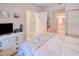 Primary bedroom with a white dresser and access to the bathroom at 3228 Purple Martin Dr # 113, Punta Gorda, FL 33950