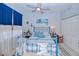 Bedroom with blue metal bed frame and nautical decor at 3228 Purple Martin Dr # 113, Punta Gorda, FL 33950