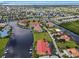 Wide aerial view of waterfront community, highlighting a condo building with red tile roof at 3228 Purple Martin Dr # 113, Punta Gorda, FL 33950