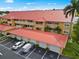 Aerial view of condo building featuring a red tile roof and private garages at 3228 Purple Martin Dr # 113, Punta Gorda, FL 33950