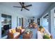 Relax on this covered patio, featuring comfortable seating and a ceiling fan for outdoor enjoyment at 7379 Snow Dr, Englewood, FL 34224