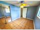 Bedroom with tile floor, ceiling fan and mirrored closet at 8362 Osprey Rd, Englewood, FL 34224