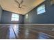 Bright bedroom with tile floors, ceiling fan, and large windows at 8362 Osprey Rd, Englewood, FL 34224