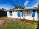 White single story home with blue shutters and landscaping at 8362 Osprey Rd, Englewood, FL 34224