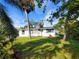 House with palm trees, grassy lawn, and lush landscaping at 8362 Osprey Rd, Englewood, FL 34224