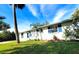 Side view of a house showcasing its landscaping and curb appeal at 8362 Osprey Rd, Englewood, FL 34224