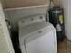 Laundry area with washer, dryer and hot water heater at 8362 Osprey Rd, Englewood, FL 34224