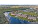Aerial view showing waterfront community, lush landscaping, and boat docks at 1352 Rock Dove Ct # B204, Punta Gorda, FL 33950