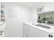 Bright laundry room with washer, dryer, and shelving at 1352 Rock Dove Ct # B204, Punta Gorda, FL 33950