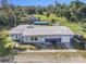 Aerial view of a single-story home with a pool and detached building on a large lot at 1507 Lavilla Rd, Punta Gorda, FL 33950