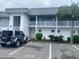 Front view of a two-story condo building with parking at 22375 Edgewater Dr # 125, Punta Gorda, FL 33980