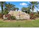 River Strand community entrance with stonework and landscaping at 7607 Grand Estuary Trl # 104, Bradenton, FL 34212