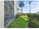 Screened patio with table and chairs overlooking the grounds at 7607 Grand Estuary Trl # 104, Bradenton, FL 34212