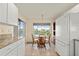 Bright kitchen with granite countertops and white cabinets, offering a view of the water at 24276 Buckingham Way, Port Charlotte, FL 33980